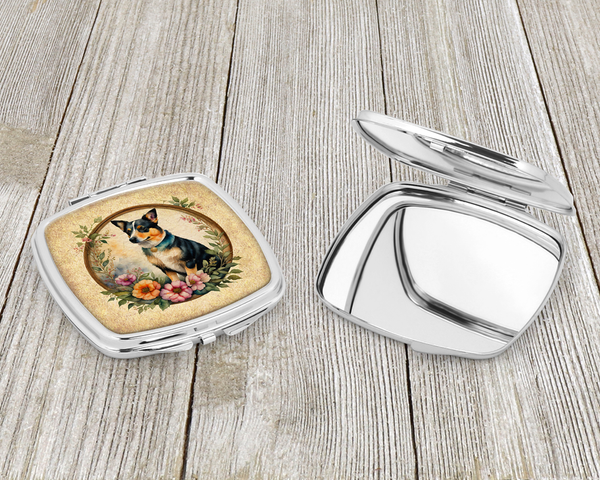 Silver compact mirror with dog-and-flowers artwork on hinged cover, open