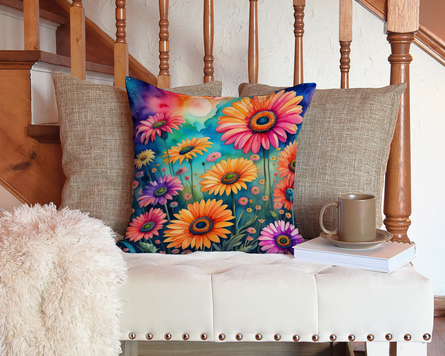 Colorful floral square pillow on a tufted sofa with a mug on the side