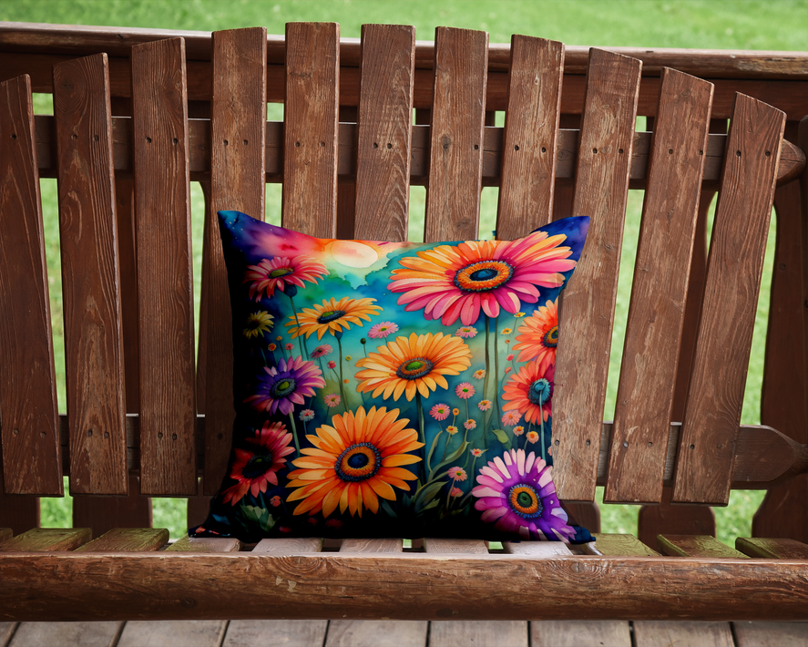 Square floral cushion with bright flower pattern on a wooden bench