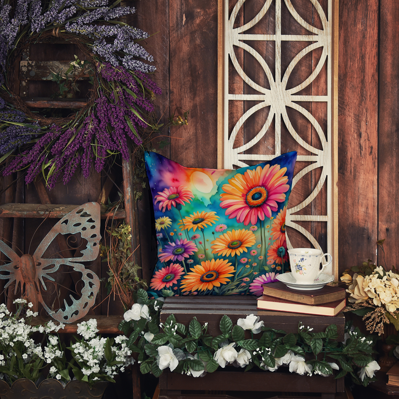 Colorful floral cushion on a wooden display with a teacup nearby