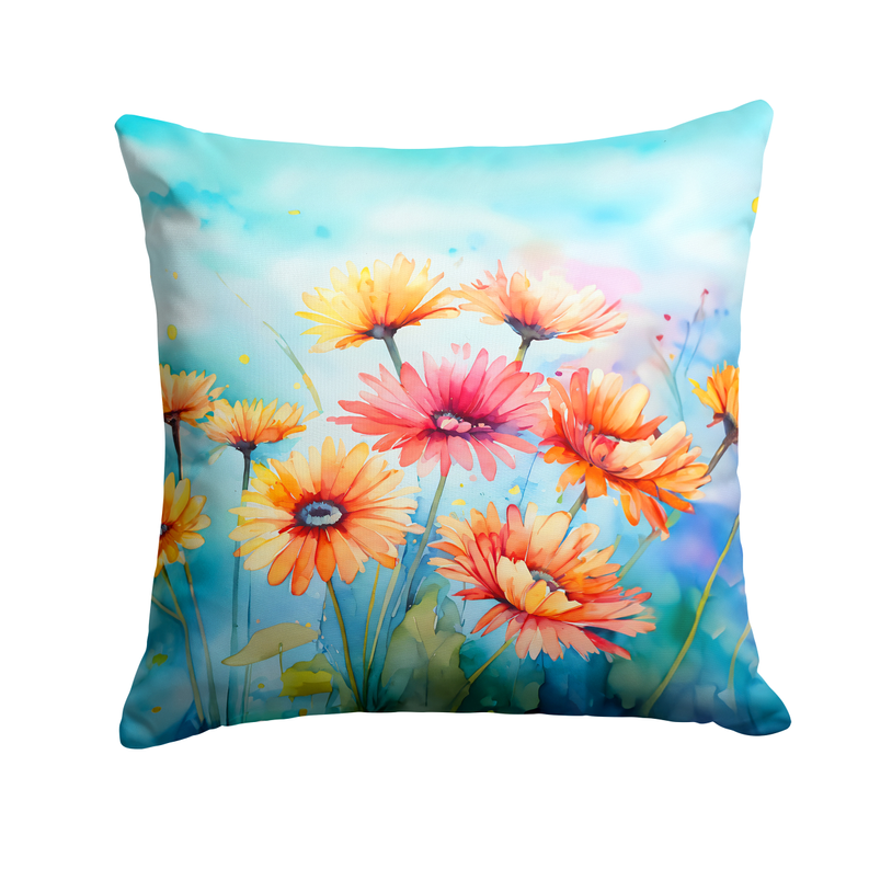 Watercolor floral throw pillow with orange, pink, and yellow gerbera-style blossoms.