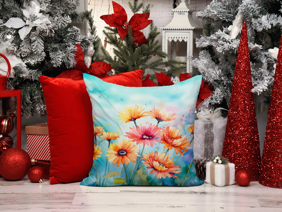 Watercolor floral throw pillow with gerbera-style flowers on a holiday table setting.