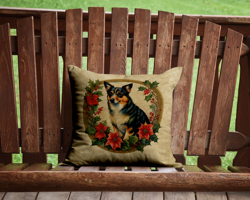 Beige dog-and-poinsettia decorative pillow on a wooden garden bench