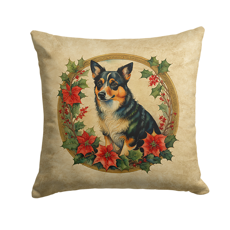 Beige square pillow with a black-and-tan dog in a poinsettia wreath