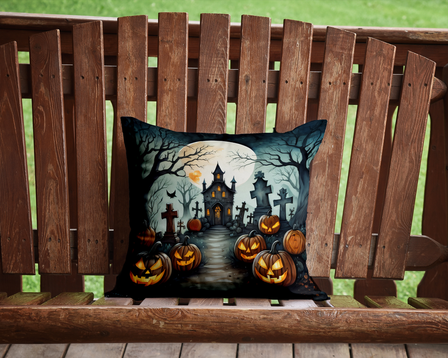 Halloween pot holder artwork on pillow with flying witch, graveyard, and orange pumpkins