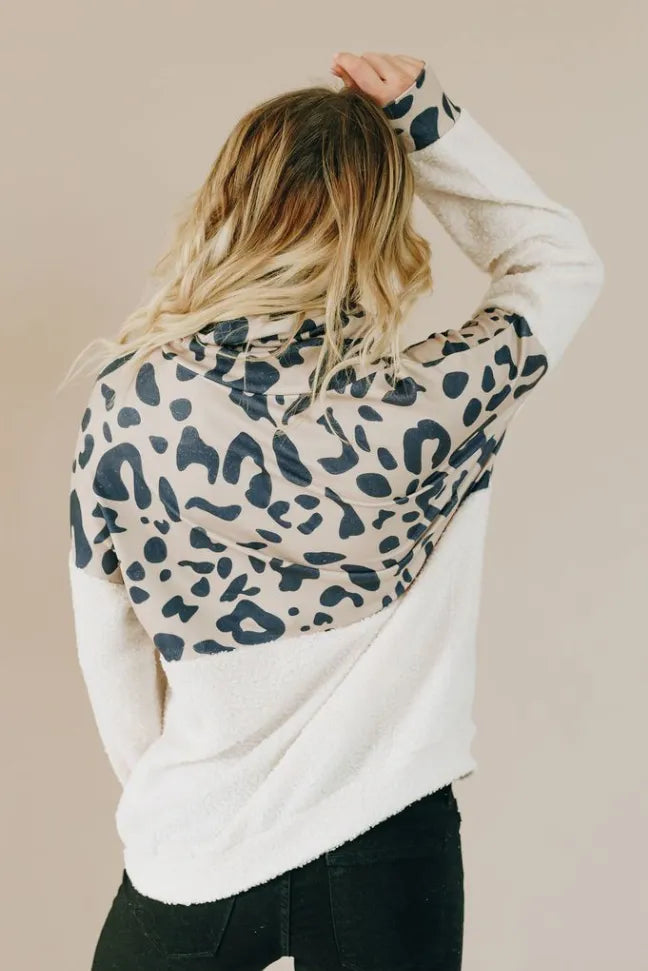 Spotted leopard pullover hoodie in white with blue pattern, hood up