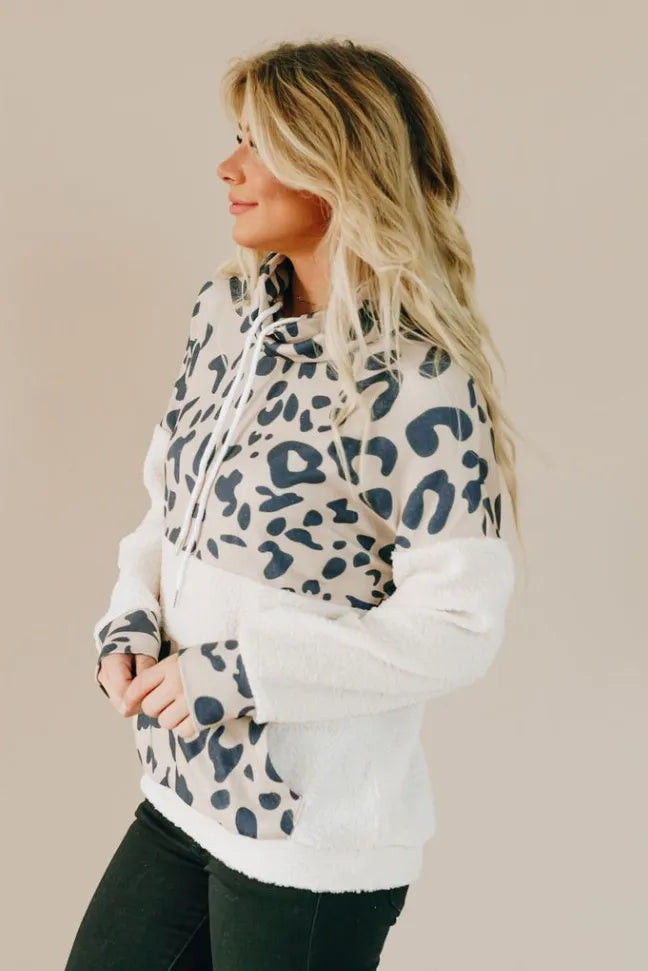 White spotted leopard pullover hoodie with blue pattern, side profile