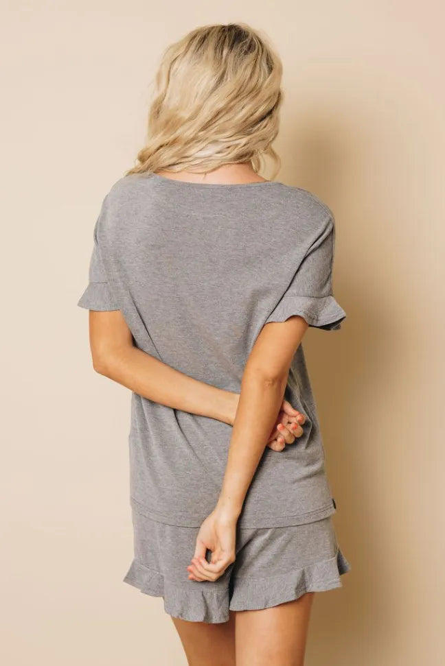 Dark gray ruffle-trim lounge set from back: short-sleeve top and drawstring shorts