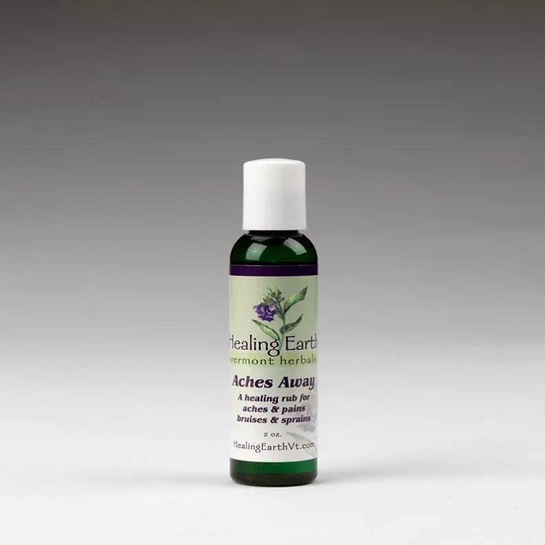 Healing Earth massage oil bottle, white cap, dark green bottle with herb label front