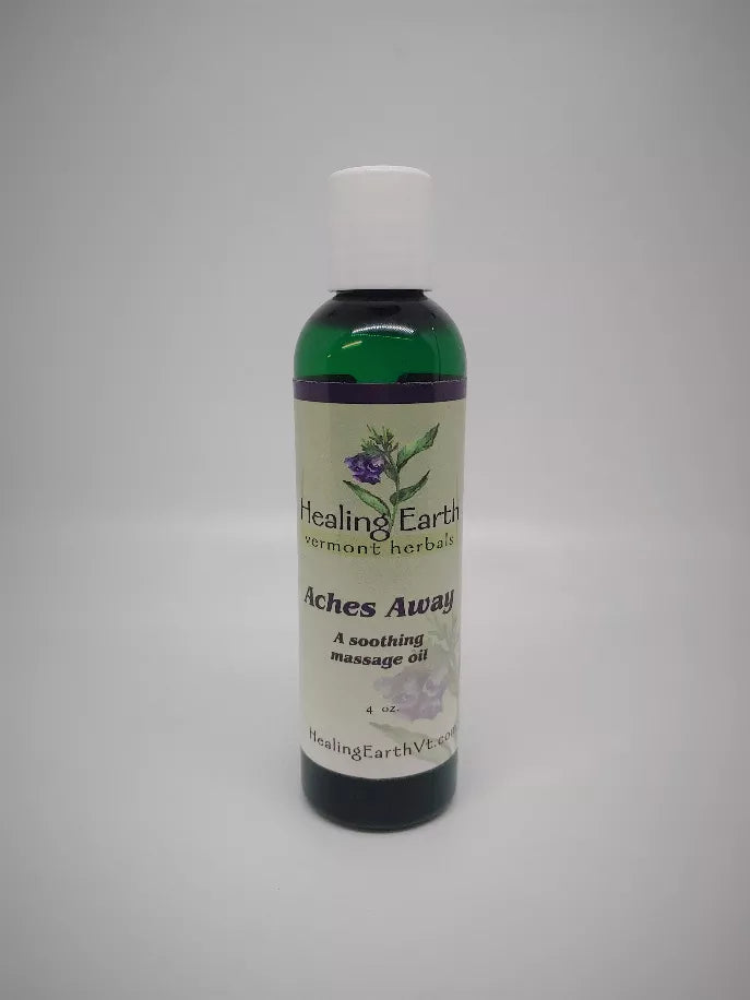 Healing Earth massage oil bottle, dark green bottle with white cap, label text visible