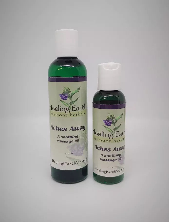 Healing Earth massage oil set, two dark green bottles with white caps and herb labels