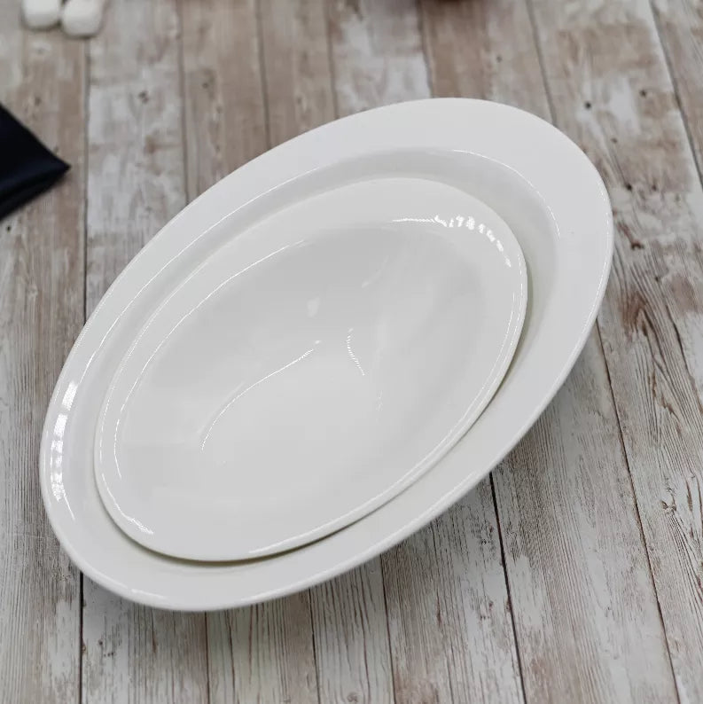 White oval ceramic bowl, 8.5 x 6 in, glossy finish close-up
