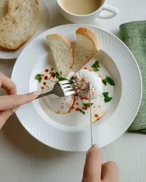 White embossed dinner plate with textured rim, served with cut bread pieces