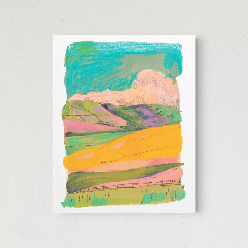 Colorful framed abstract landscape print with teal sky, peach hills, and yellow road