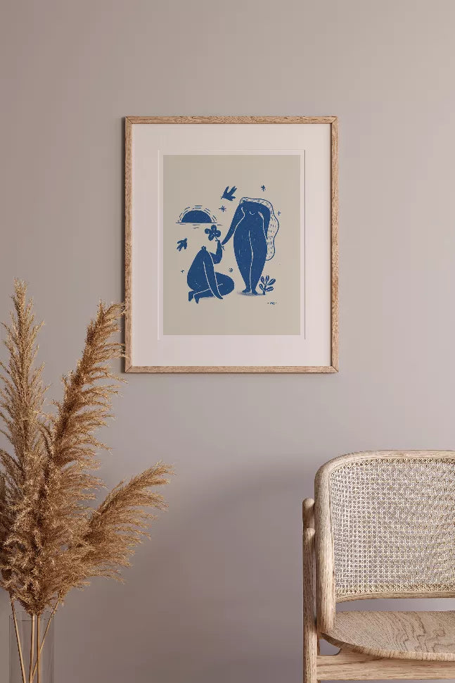 Framed illustrated art print with blue couple and plants, light wood frame