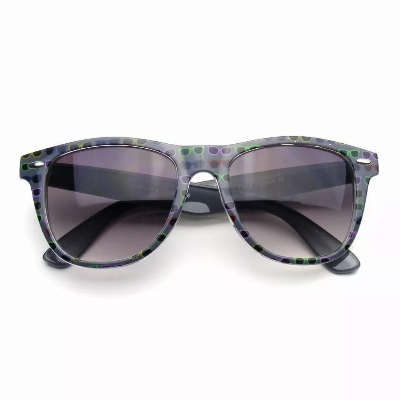 Horned rim sunglasses with gray frame and green dot print, dark tinted lenses