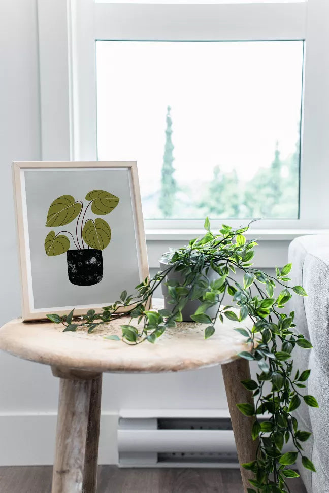 Framed peperomia wall art print with green leaf drawing and black pot