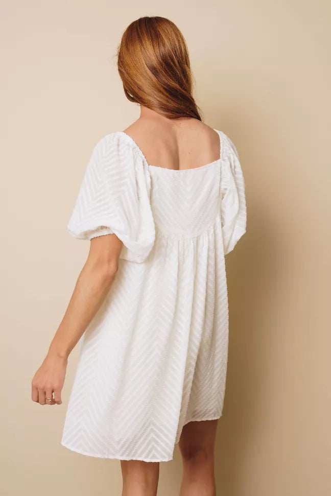 White babydoll midi dress with puff sleeves, square back, and gathered waist