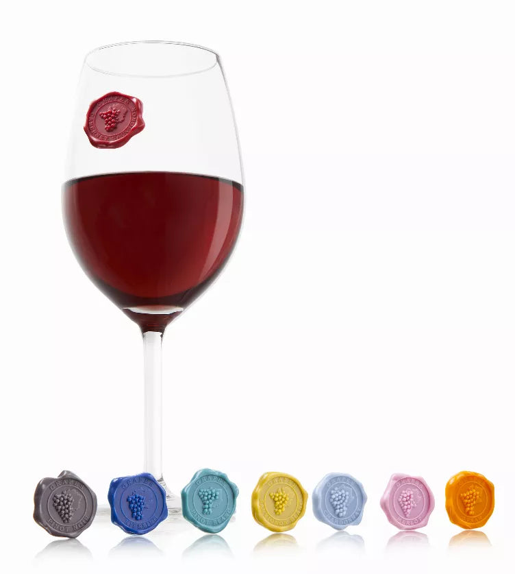 Set of 8 multicolor grape-shaped wine markers shown on a stemmed glass