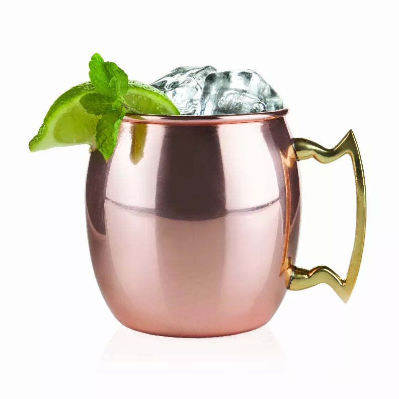 Copper Moscow mule mug by Twine with curved handle and lime garnish