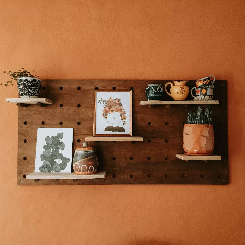 Framed floral lady wall art print with multicolor flower hair among shelf displays