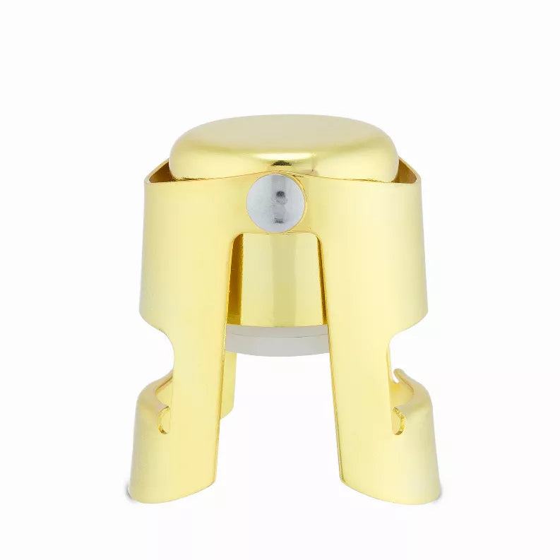 Gold champagne stopper with central pouring opening and U-shaped clamp, shiny metal.