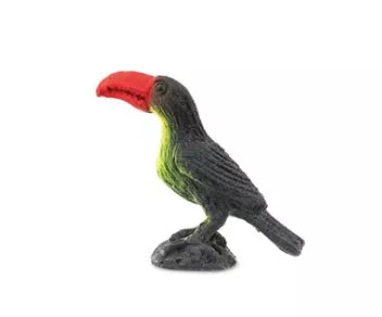 Toucan figurine with black body, green belly, and red beak, standing on base.