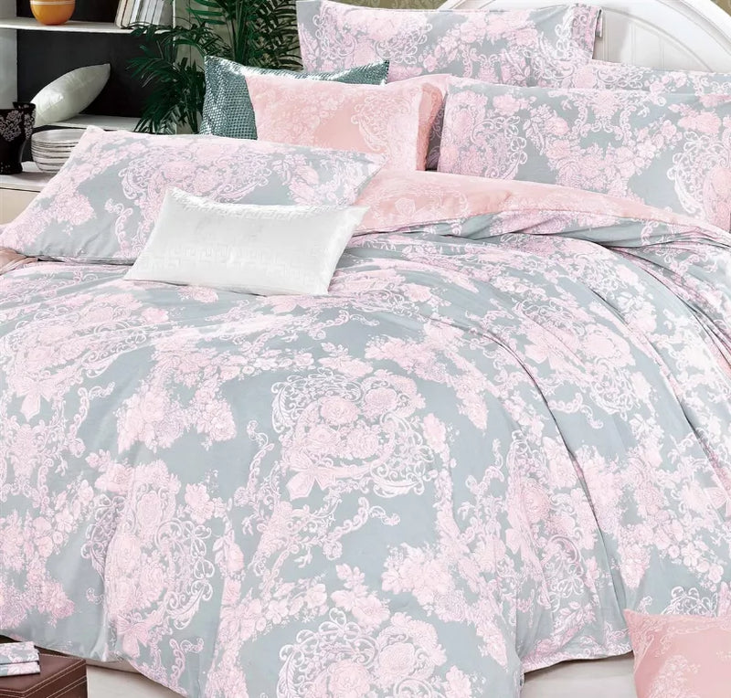 King reversible cotton comforter with pastel pink and muted gray damask pattern and pillows