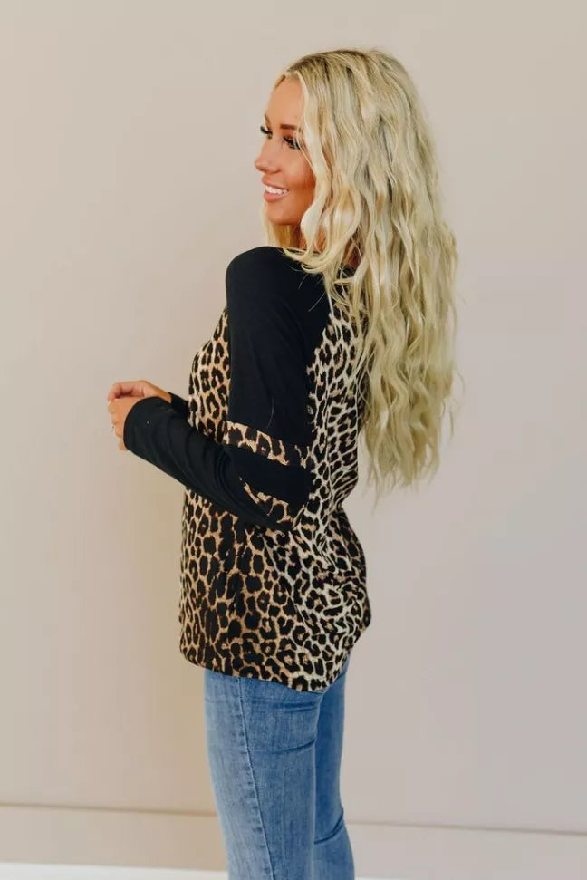 Two-tone long-sleeve tee with leopard-print center and black sleeves, banded cuffs.