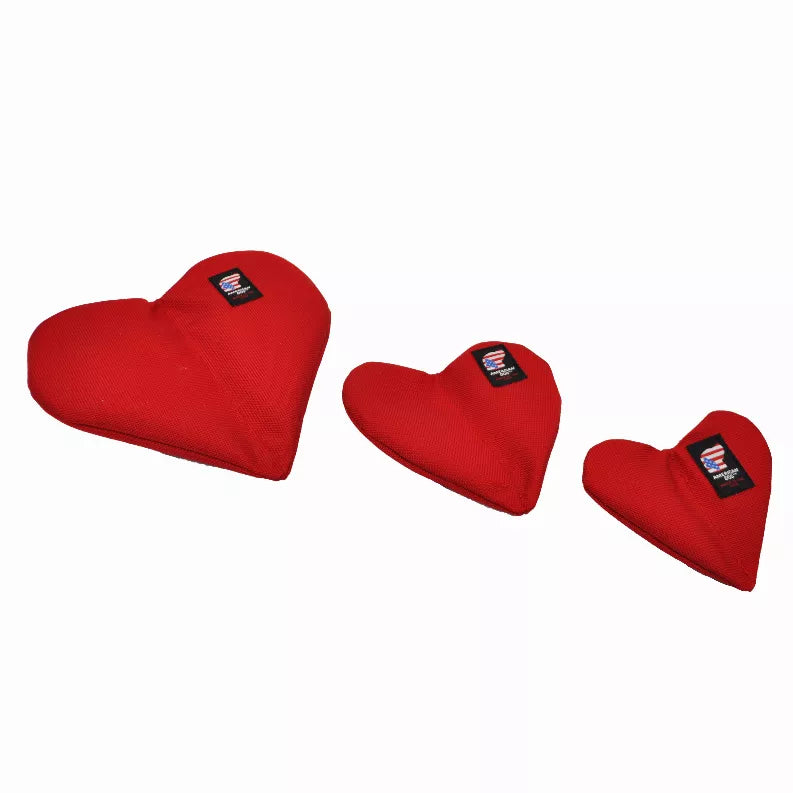 Red heart-shaped plush dog toy with black logo patch, medium size