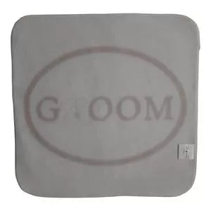 Gray square wedding washcloth with faint circular “GROOM” embroidered text