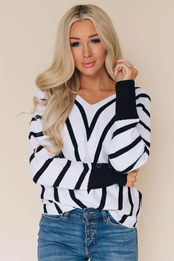 Black and white striped V-neck sweater with long sleeves and ribbed cuffs