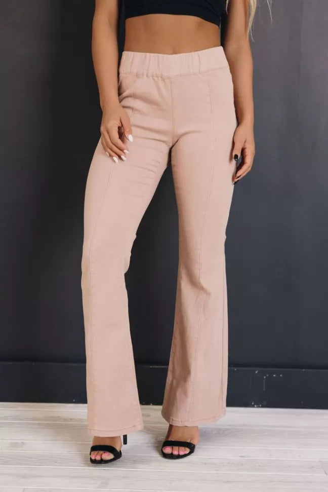 Light beige high-rise flare jeans with back yoke seams and wide flared hems
