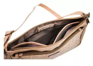 Natural cork crossbody bag open to show interior pockets and dark lining; shoulder strap.