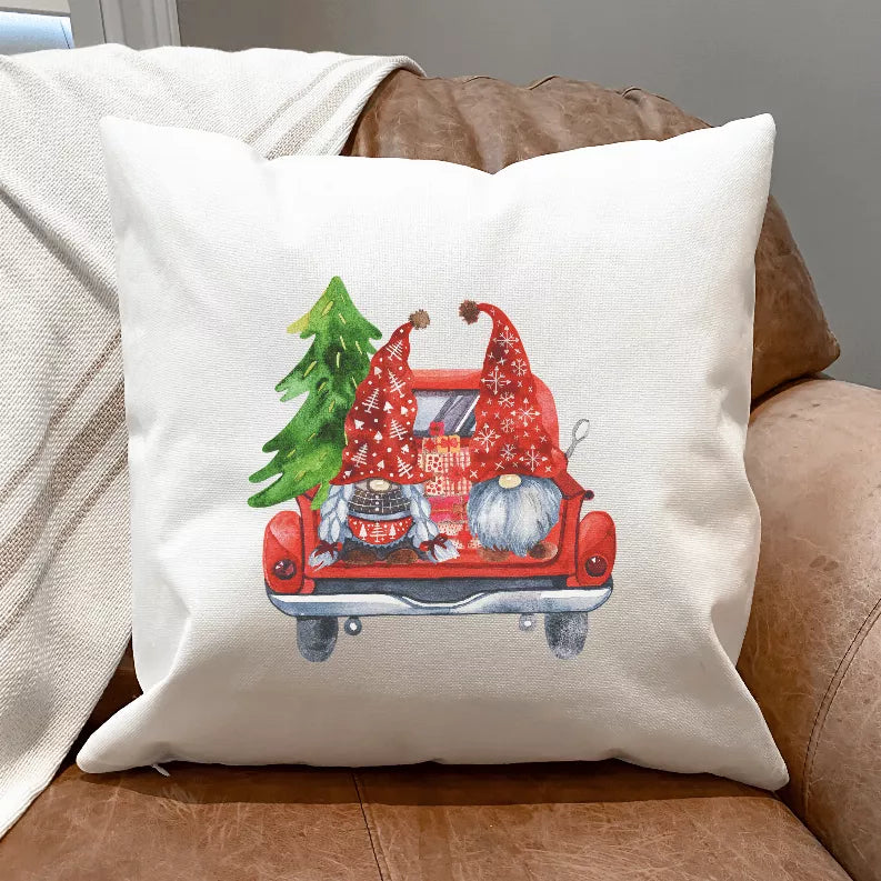 White pillow cover with red truck gnome illustration and green tree