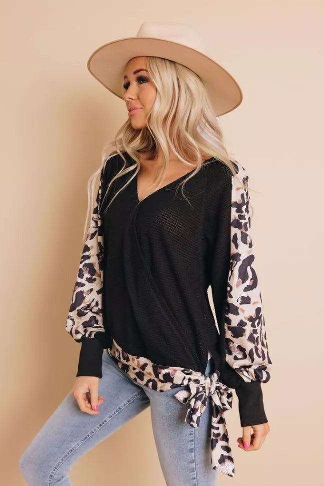 Black V-neck leopard print top with long sleeves and tied waist hem, front view
