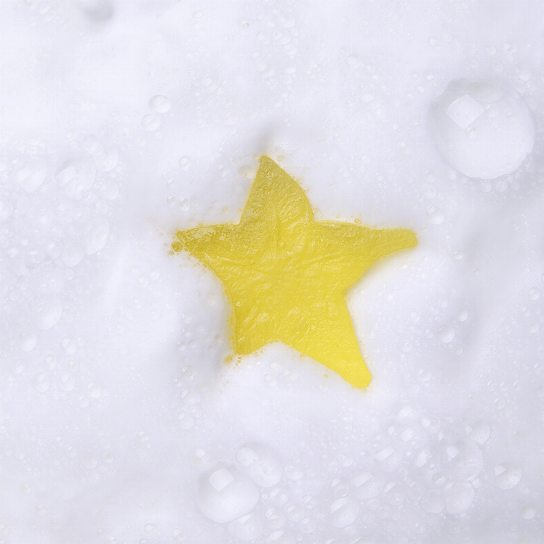 Yellow star soap bar with visible texture and droplets