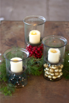 Set of clear mini glass candle cylinders with rustic inserts and burning candles