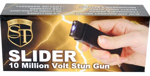 Black stun gun flashlight shown in retail package, hand holding device
