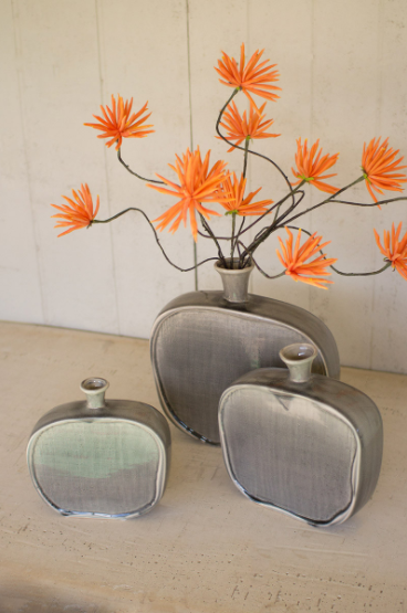 Set of three textured grey ceramic flat bottles with wide openings
