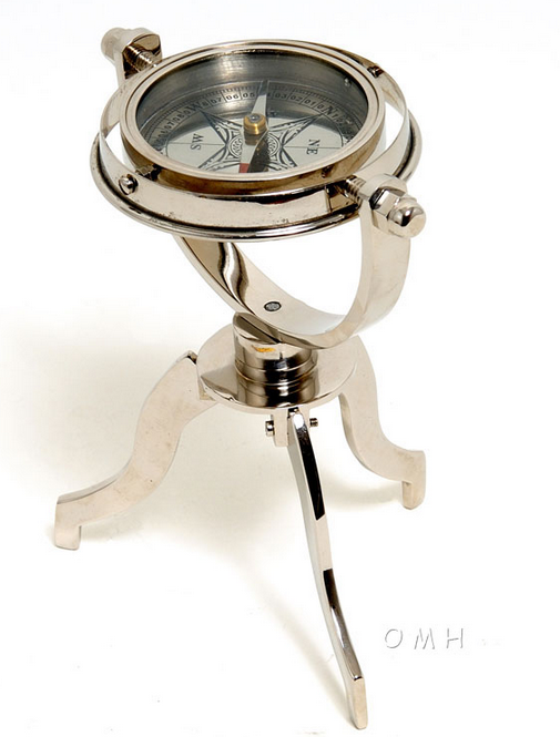 Brass gimbaled compass with tripod stand and glass face, needle visible