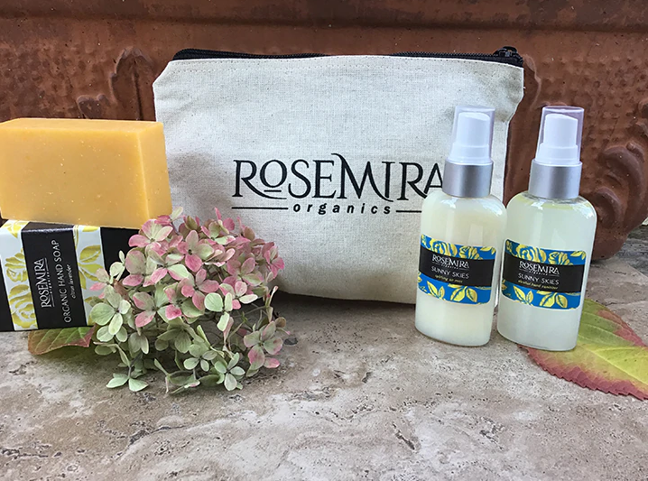 Holiday sanitizer kit with ROSEMIRA organics pouch, two spray bottles, and soap bars