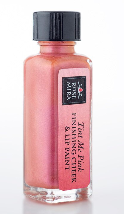Pink cheek & lip paint in clear glass bottle with black cap and 'Tint Me Pink' label