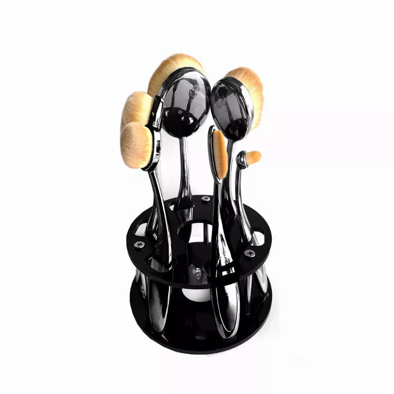 Black oval brush caddy holding six beauty brushes with soft beige bristles