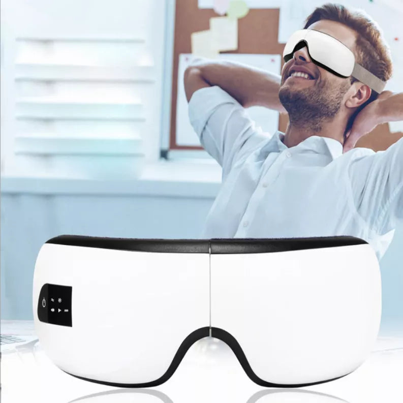 White eye massager with black control panel and forehead strap, hot/cold style