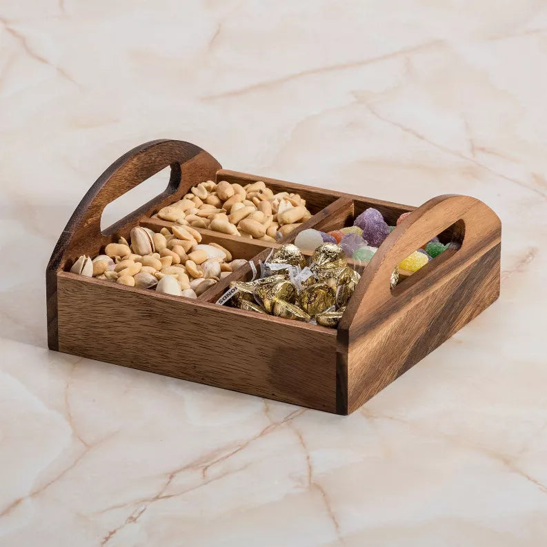 Wooden 4-compartment snack tray with built-in handles, holding mixed snacks in sections