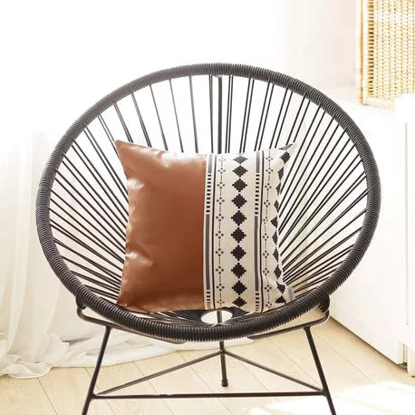 Brown faux leather throw pillow with boho patterned center panel and tassel trim