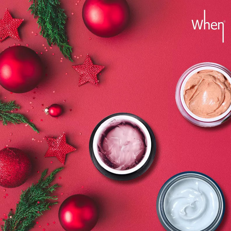 Three cream mask jars with peach, purple, and white creams on a red holiday background