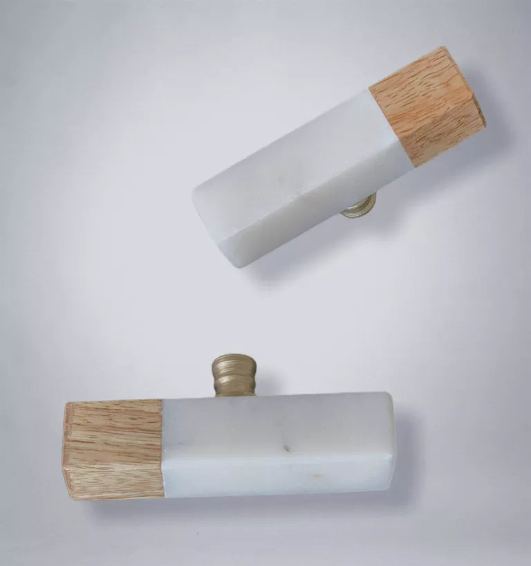 White stone and wood cabinet pull with brass center screw