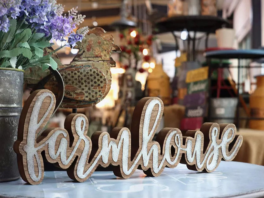 Farmhouse freestanding word sign in brown wood with white distressed lettering on tabletop